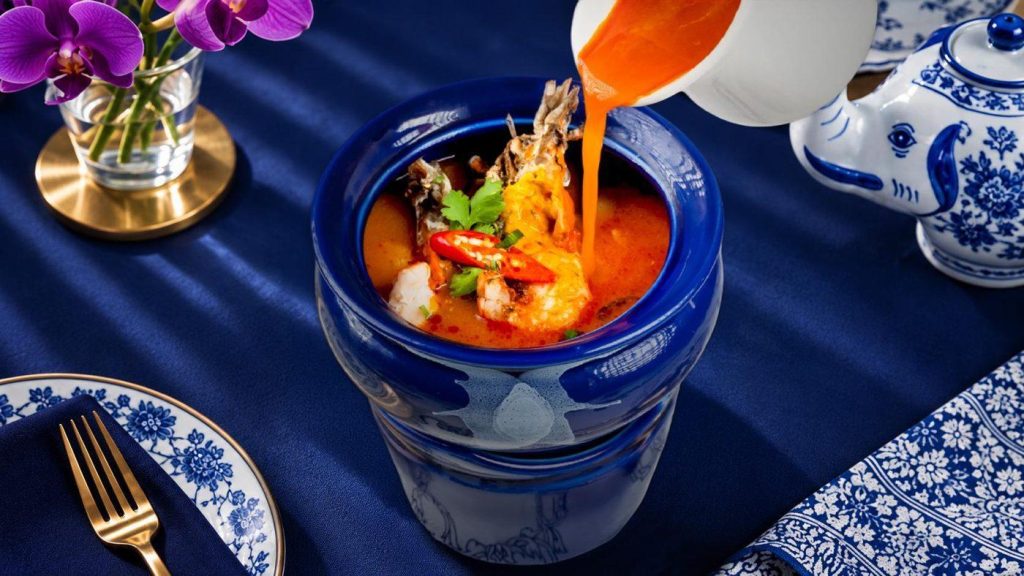Spicy Thai Tom Yum soup with chilli served in a blue Blue Elephant bowl