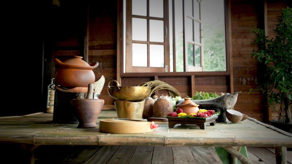 Traditional Thai kitchen with clay pots and a mortar, reflecting the history of Thai fruit carving